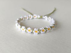 a white and yellow flower headband on a table