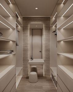 an empty walk - in closet with white shelves and lights on the ceiling, along with a bench