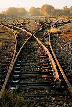 an old train track with two sets of railroad tracks running parallel to each other in the distance