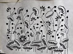 an intricately designed piece of paper with flowers on it