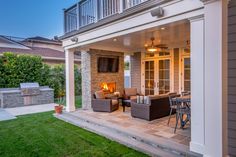 an outdoor living area with patio furniture and fireplace