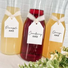 three jars filled with liquid sitting on top of a table