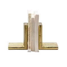 two gold bookends are stacked on top of each other, with one standing upright