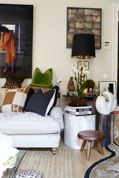 a living room filled with lots of furniture and decor