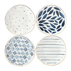 four plates with blue and white designs on them