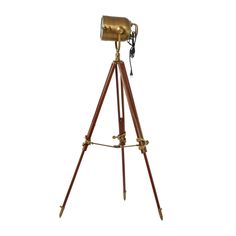 an antique brass tripod lamp on a white background