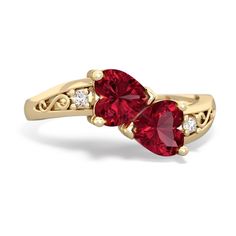 two hearts shaped red stone ring with diamonds on the sides, set in yellow gold