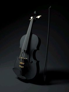 a black violin with gold strings on a dark background