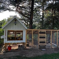 a chicken coop built into the side of a tree