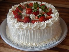 a cake with white frosting and strawberries on top