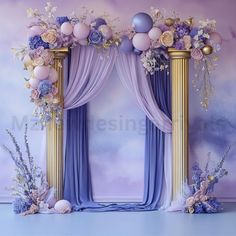 a purple and gold wedding arch decorated with flowers, balloons and other decorations in front of a wall