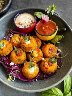 some food is sitting on a plate with sauces and herbs in the bowl next to it