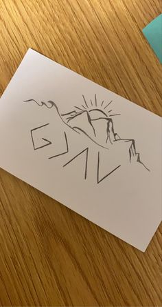 a piece of paper that has been drawn on top of a table with a pen