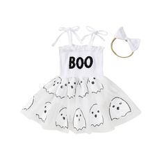 a white dress with ghost faces on it and a headband in the shape of a bow