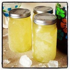 two jars filled with lemonade sitting on top of a counter