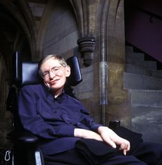 a man sitting in a chair with his legs crossed