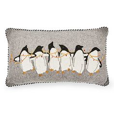 a grey pillow with penguins on it