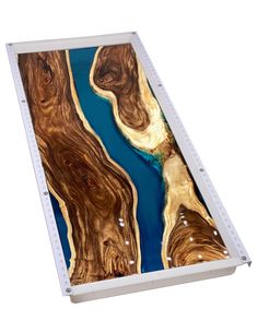 an image of a wooden table with blue water in the center and trees on it