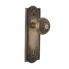 an antique door handle with a decorative design on the front and side panel, shown in bronze