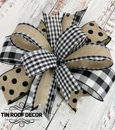 a black and white polka dot bow on a wooden surface