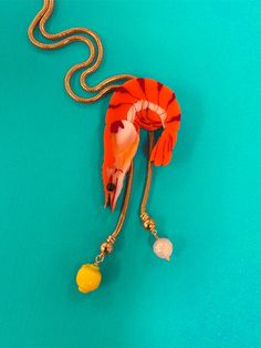 Paradise lost 🦐 One of the most fun we've seen on a bolo--the shrimp slides on a gold-plated snake chain and is adorned with a handmade lampwork glass lemon and pearl. ✦ Handmade and pressed in acrylic and mounted on wood. ✦ Made with ✨ in Kansas City, MO. ✦ As much as possible, keep out of humid areas like the bathroo