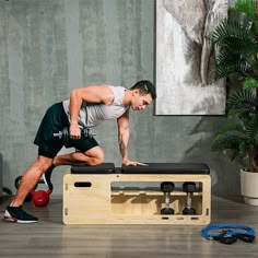 a man doing exercises on a bench in the middle of a room with other equipment