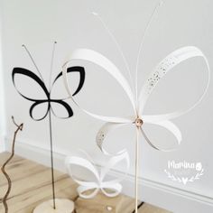 two white and black decorative items sitting on top of a wooden floor