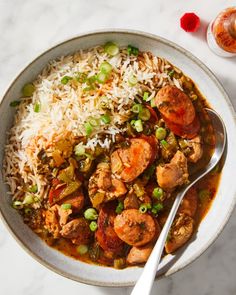 a bowl filled with rice, meat and vegetables