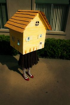 a person wearing a cardboard house costume