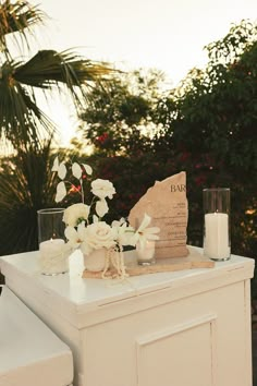 a table with flowers and candles on it