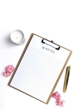 a notepad with the words notes on it next to a cup of coffee and pink flowers