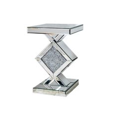 a mirrored table with a diamond shaped base