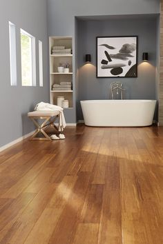 a bathroom with hardwood floors and a tub