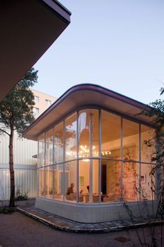 a house that is sitting in the middle of a yard with windows on each side