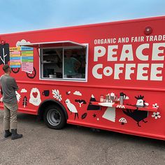 a man standing in front of a red food truck with the words peace coffee painted on it