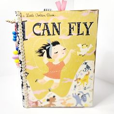 This classic Little Golden Book, I Can Fly, has been upcycled into a dreamy junk journal! Over 70 pages of fun cardstock, writing and scrapbook papers have been hand sewn around the original story that remains in order. Many pockets, envelopes and tuck spots with a handmade dangle bookmark! Edges of the cover have been gilded in gold paint and book comes wrapped with a pretty bow!!  Makes for an amazing gift! Ready to ship!! Please shop my store for other titles at https://journalinggems.etsy.co Little Golden Book Junk Journal, Golden Book Junk Journal, Book Junk Journal, Unique Graduation Gifts, Travel Notebook, Journal Travel, Journal Handmade, Golden Book, Gift For Daughter