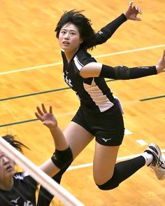 two girls are playing volleyball on the court