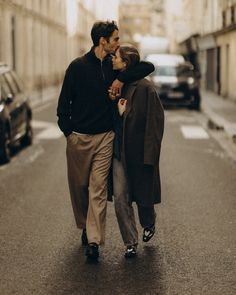 a man and woman walking down the street together