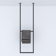 a towel rack with two towels hanging from it's sides and one folded up