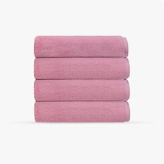 four pink towels stacked on top of each other