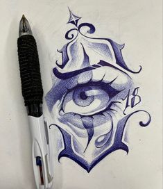 an eye drawn on paper next to a pen