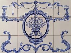 a blue and white tile wall with ornate designs