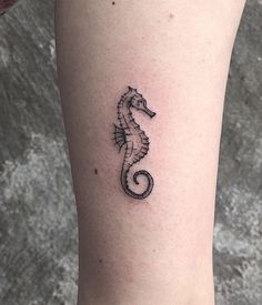 a small sea horse tattoo on the leg