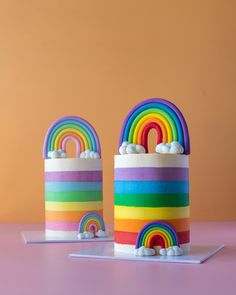 there are two rainbow cakes on the table