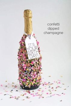 a bottle filled with confetti and a sign that says it's your birthday