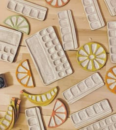 some oranges, lemons and bananas are arranged on a wooden table with mold