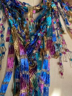 Multicolor scarf for women. Unique scarf handmade for women. Boho scarf for festivals and formal gatherings. Stunning color combination with gold makes this a showstopper. Fuchsia, royal blue, teal green, brass gold with lot of gold metallic sparkle, if you love lot of bling and color this is the accessory for you.  Wear it with matching color jewelry to complete your look. Very rich looking scarf. Masquerade ball comes mind with this color combination. Hand wash in lukewarm water with mild soap, don't rub or wring, squeeze of excess water and hang to dry.  Comes with nice organza satchel for traveling or gift giving. Store the ribbon scarves flat in a drawer or hang them up.  Handmade in United States of America.  Visit the store front at  www.Etsy.com/shop/thinkerbella for more color and Traditional Scarves For Festivals As Gifts, Traditional Scarf For Festivals As A Gift, Gold Shawl For Party And Festivals, Bohemian Gold Dupatta For Celebration, Elegant Multicolor Dupatta For Party, Elegant Shawl For Parties And Festivals, Elegant Multicolor Party Dupatta, Multicolor Silk Shawl Scarf For Festive Occasions, Festive Multicolor Silk Shawl Scarf