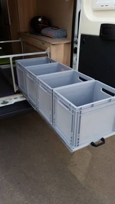 the back end of a trailer with three storage bins