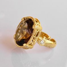 Smokey Quartz & Diamond Ring in 18k Solid Gold, This beauty is part of our exclusive a one of a Kind creation collection * 18k solid Gold * Pristine natural 1x1.8cm faceted Oval Smokey Quartz Gemstone * 2 Vs si Brilliant quality 0.3ct Diamonds * All our Stones are Ethically sourced. * Size adjustment from 5us to 8 us Included * Price includes shipping * Custom duty charges are regulated by your country upon delivery. There is no custom duty charges for all orders delivered to the EU countries. * For time sensitive orders please let us know and we will do our best to accommodate you Custom orders Welcomed! Luxury Yellow Gold Topaz Ring With Diamond Accents, Luxury 14k Gold Topaz Ring, Elegant Oval Diamond Cut Topaz Ring, Elegant Yellow Gold Topaz And Diamond Ring, Elegant Faceted Yellow Gold Topaz Ring, Luxury Topaz Ring With Rose Cut Diamonds, Luxury Faceted Rings For Formal Occasions, Luxury Yellow Gold Topaz Ring With Diamond, Luxury 14k Gold Diamond Ring With Gemstones