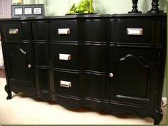 a black dresser with many drawers and knobs